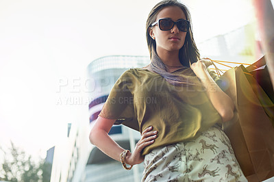 Buy stock photo Shopping bag, urban portrait and confident woman with fashion clothes present, retail choice or stylish store product. Fashionable, pride and chic female customer with glasses, sales spree and wealth