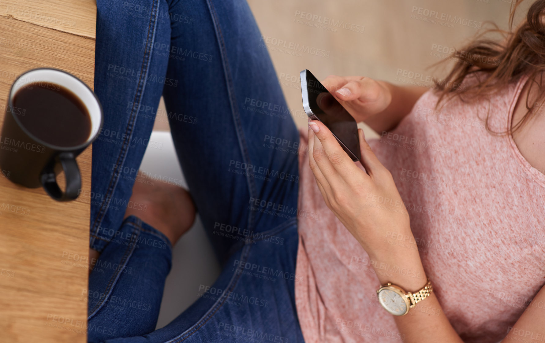 Buy stock photo Shot of a young woman using a cellphone at home