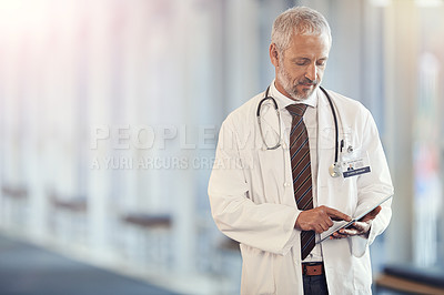 Buy stock photo Typing, communication and a doctor with a tablet for healthcare, consulting and cardiology. Hospital, consultant and a mature surgeon with technology for a clinic schedule, agenda or planning