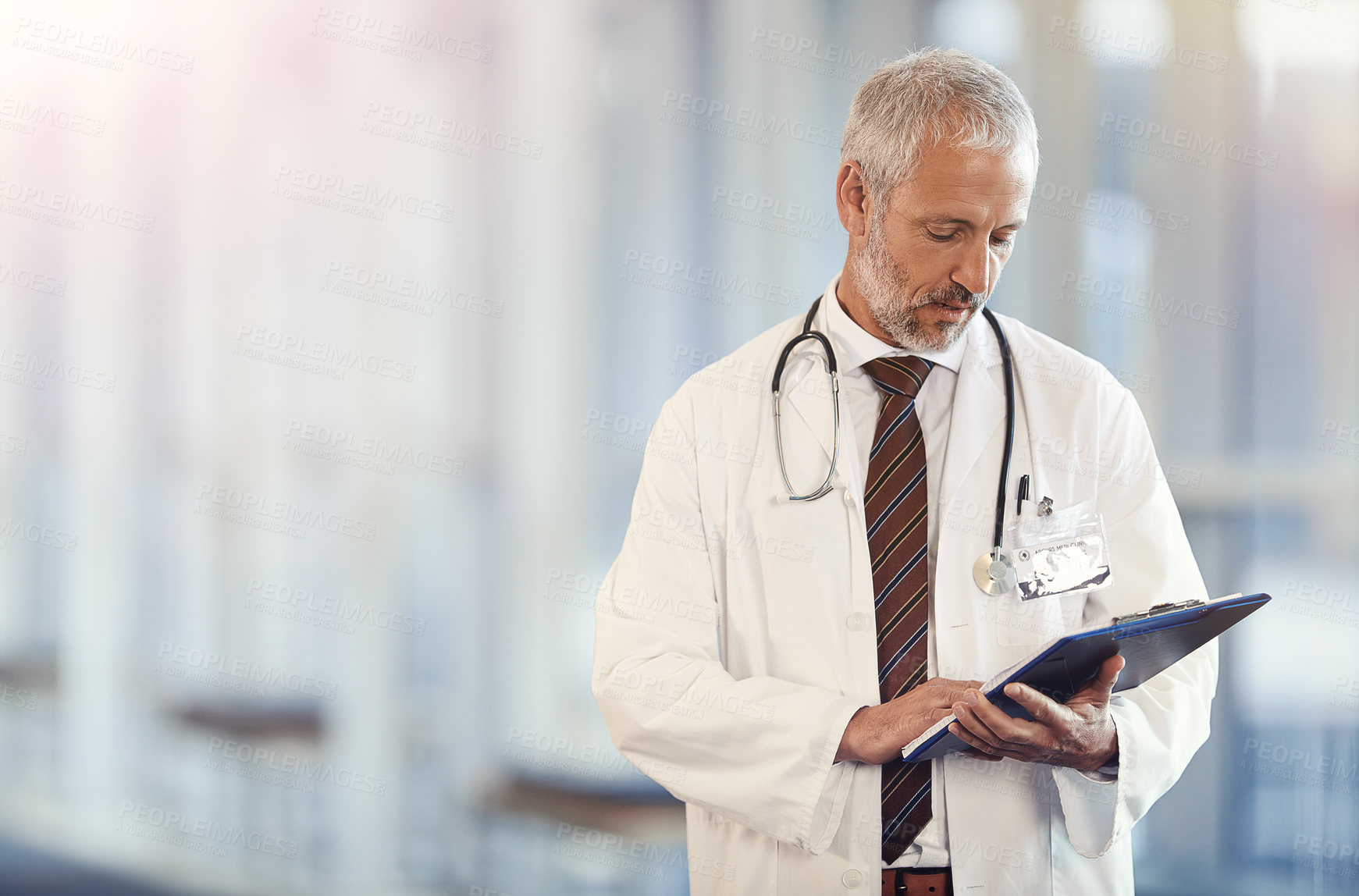 Buy stock photo Documents, healthcare and insurance with a senior doctor standing in a hospital corridor for treatment or diagnosis. Medical, trust and clipboard with a man medicine professional in a health clinic