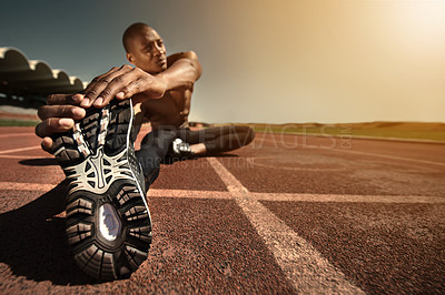 Buy stock photo Man, shoes and stretching leg on ground, sunset and fitness for health, sports and performance. Black male person, athlete and warmup on track, workout and commitment or ready, train and outdoors