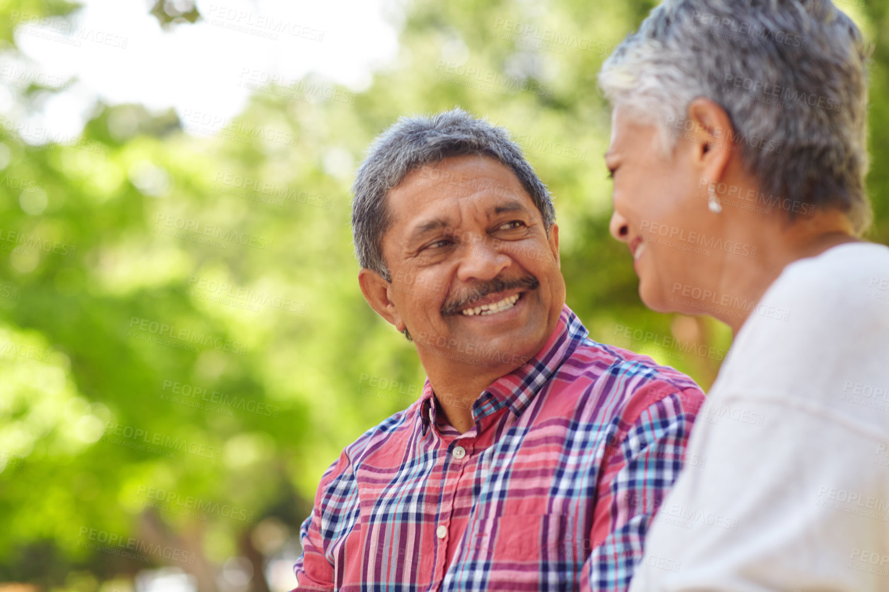 Buy stock photo Shot of a loving senior couple enjoying quality time together outdoors