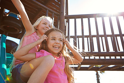 Buy stock photo Shot of little girls playing on a jungle gym