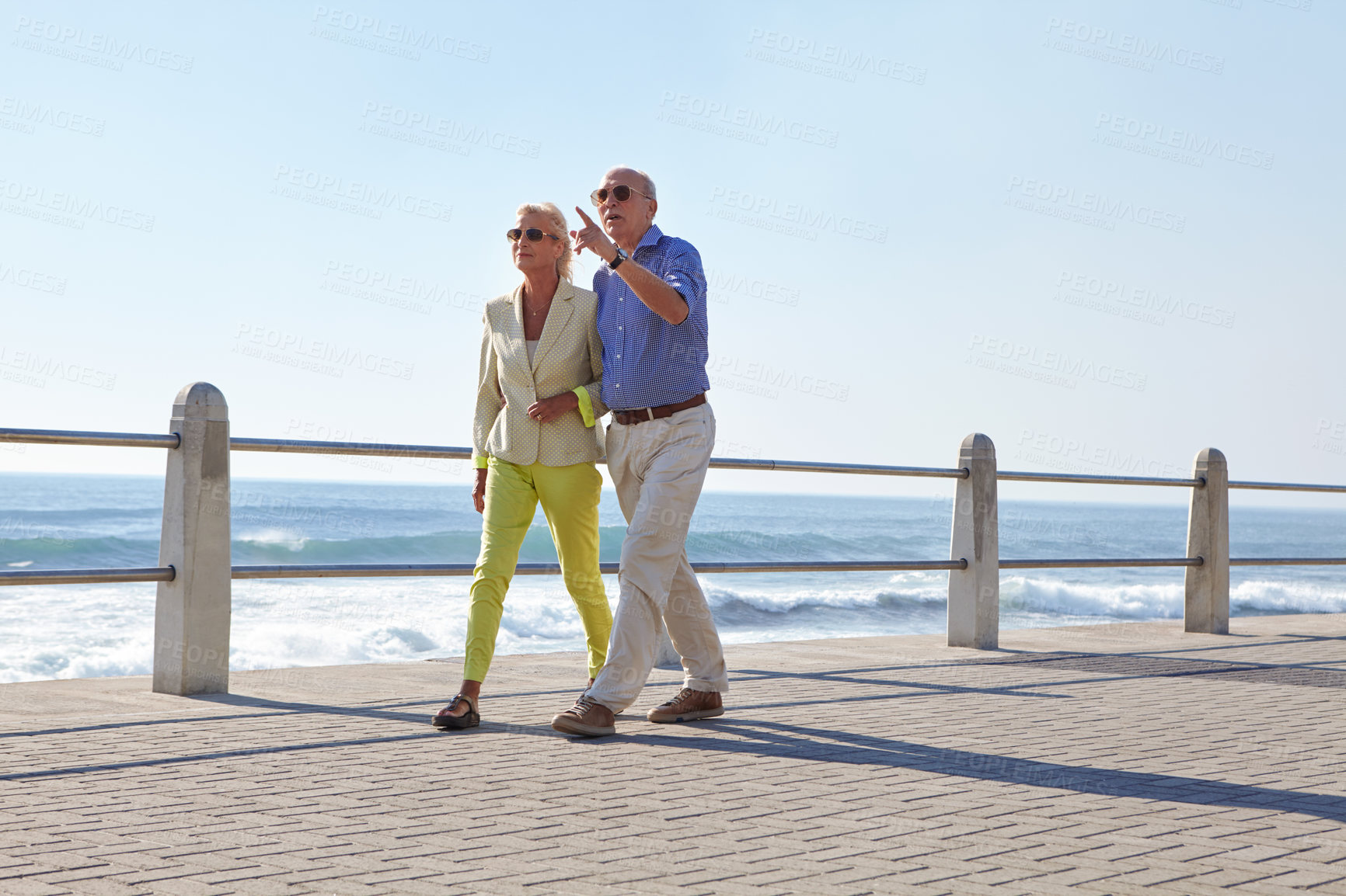 Buy stock photo Shot of a senior couple taking a walk by the ocean