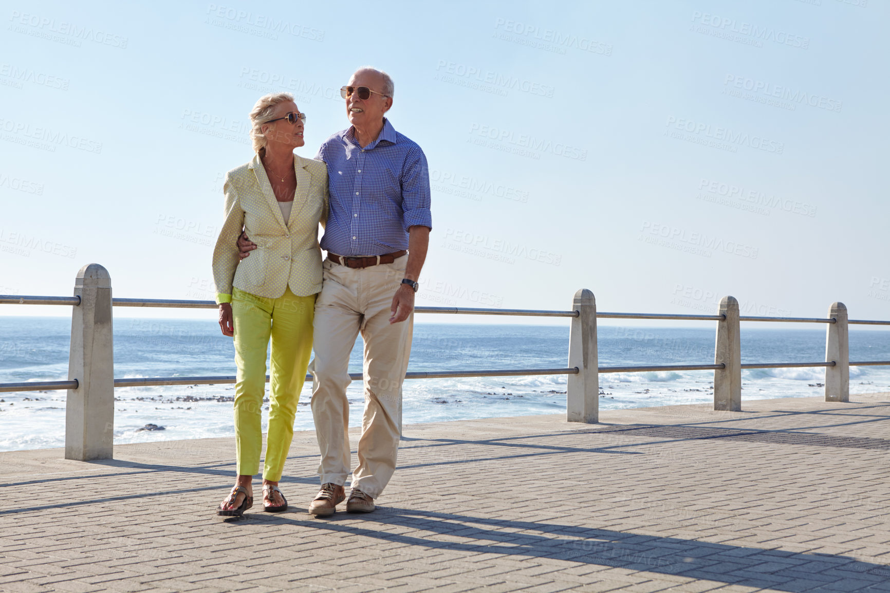 Buy stock photo Shot of a senior couple taking a walk by the ocean