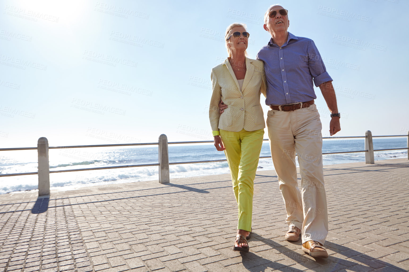 Buy stock photo Shot of a senior couple taking a walk by the ocean