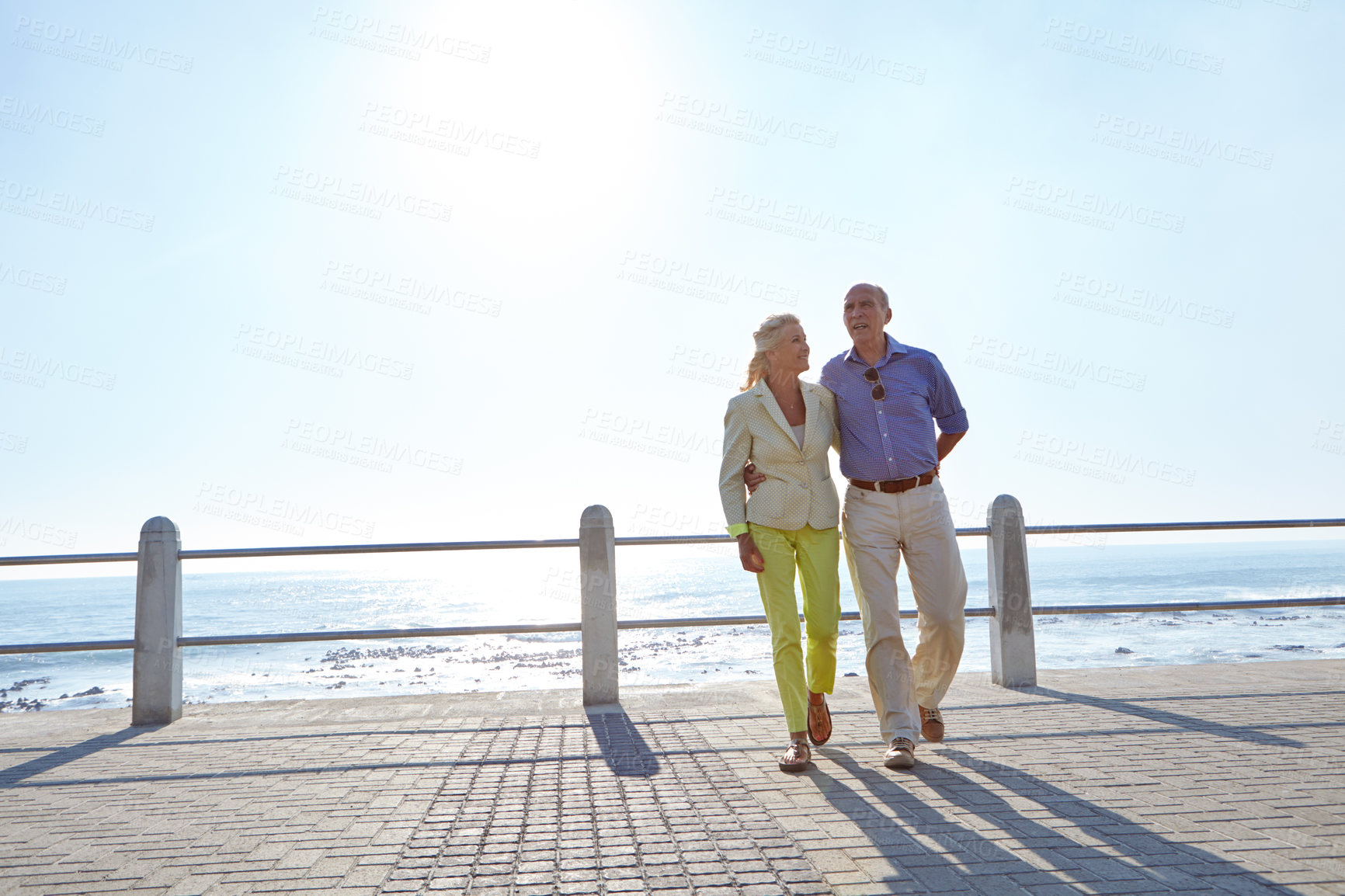 Buy stock photo Shot of a senior couple taking a walk by the ocean