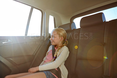 Buy stock photo Shot of a little girl traveling in a car