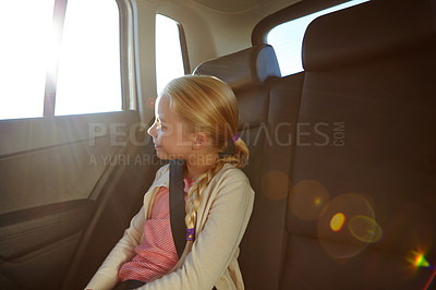 Buy stock photo Shot of a little girl traveling in a car