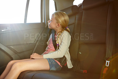 Buy stock photo Shot of a little girl traveling in a car