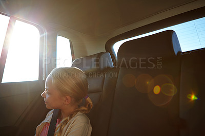 Buy stock photo Shot of a little girl traveling in a car