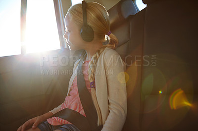 Buy stock photo Shot of a little girl traveling in a car