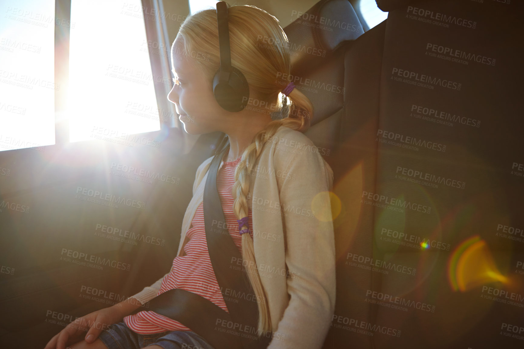 Buy stock photo Shot of a little girl traveling in a car