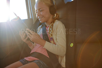 Buy stock photo Shot of a little girl traveling in a car