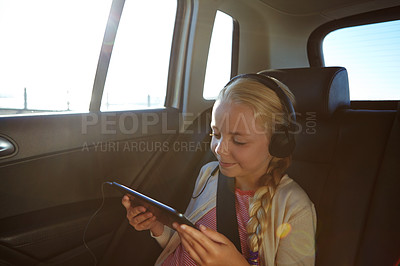 Buy stock photo Shot of a little girl traveling in a car