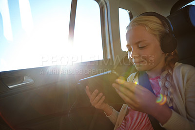 Buy stock photo Shot of a little girl traveling in a car