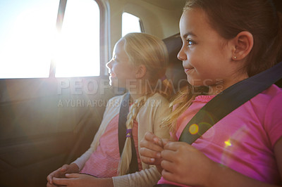 Buy stock photo Shot of a two little girls traveling in a car