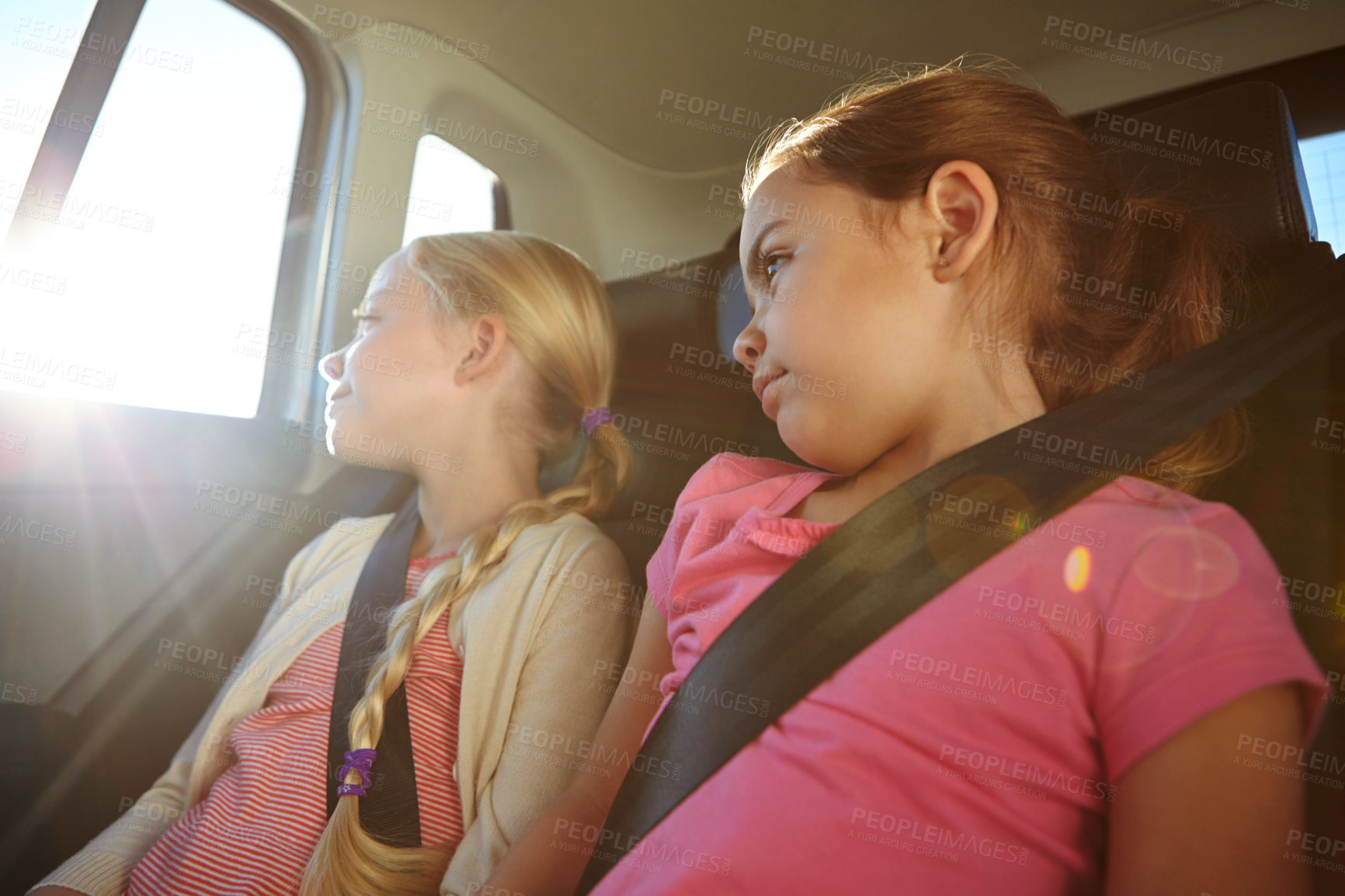 Buy stock photo Shot of a two little girls traveling in a car