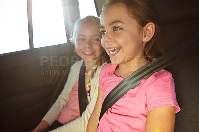 Buy stock photo Shot of a two little girls traveling in a car