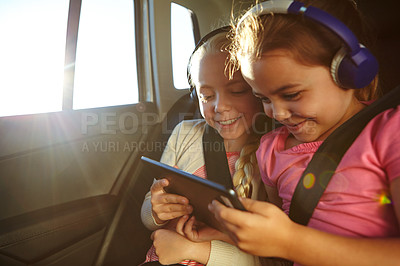 Buy stock photo Shot of a two little girls traveling in a car