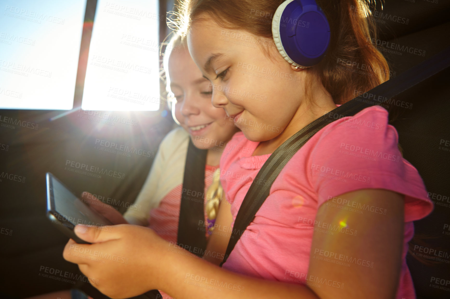 Buy stock photo Shot of a two little girls traveling in a car