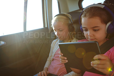 Buy stock photo Shot of a two little girls traveling in a car