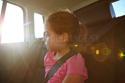 Buy stock photo Shot of a little girl traveling in a car