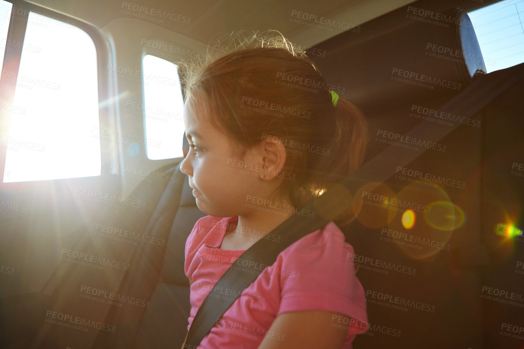 Buy stock photo Shot of a little girl traveling in a car