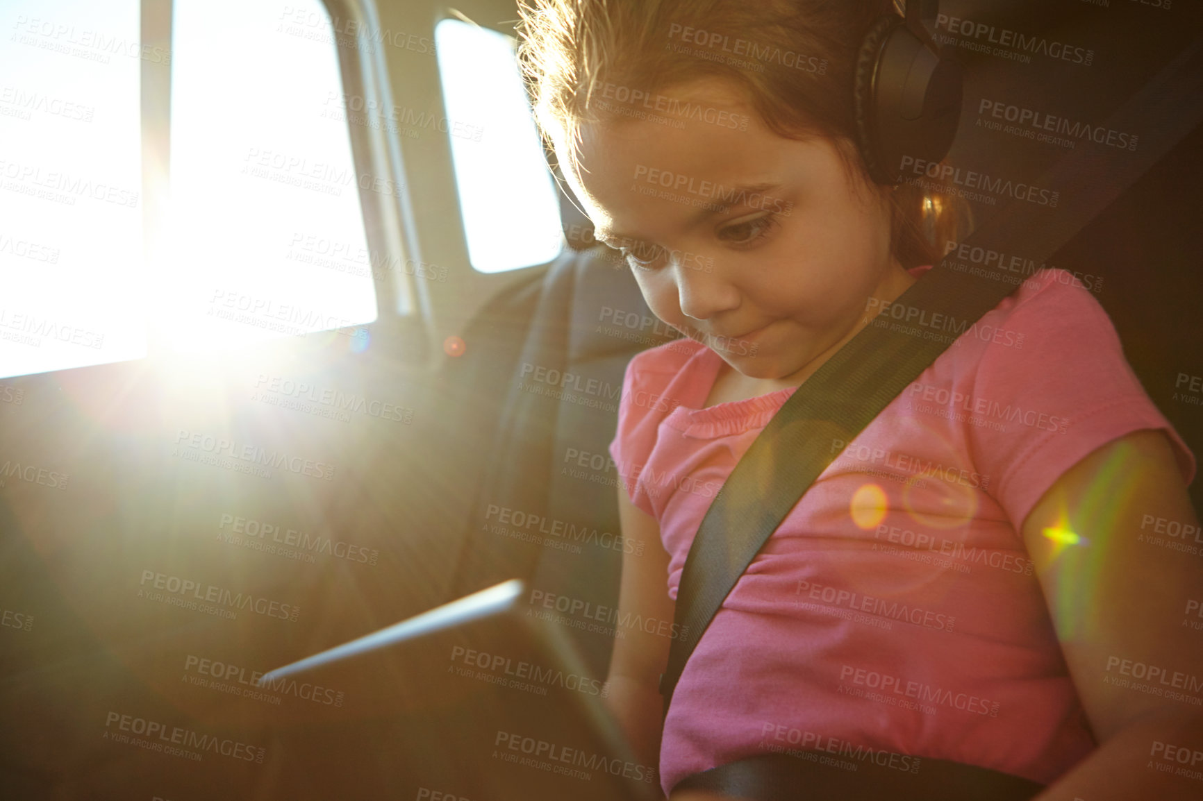 Buy stock photo Shot of a little girl traveling in a car