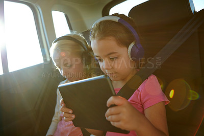 Buy stock photo Shot of a two little girls traveling in a car