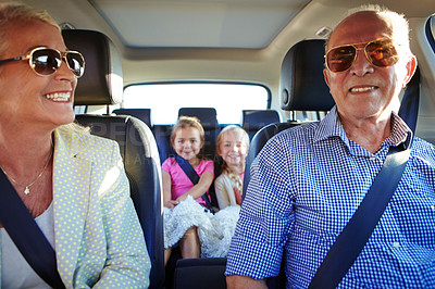 Buy stock photo Shot of two little girls going on a road trip with their grandparents