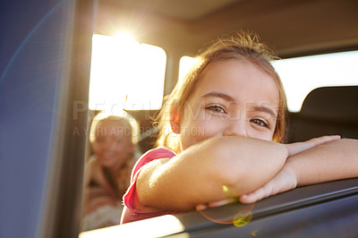 Buy stock photo Shot of a little girl traveling in a car