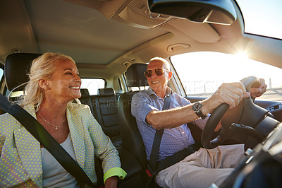 Buy stock photo Shot of a senior couple on a road trip