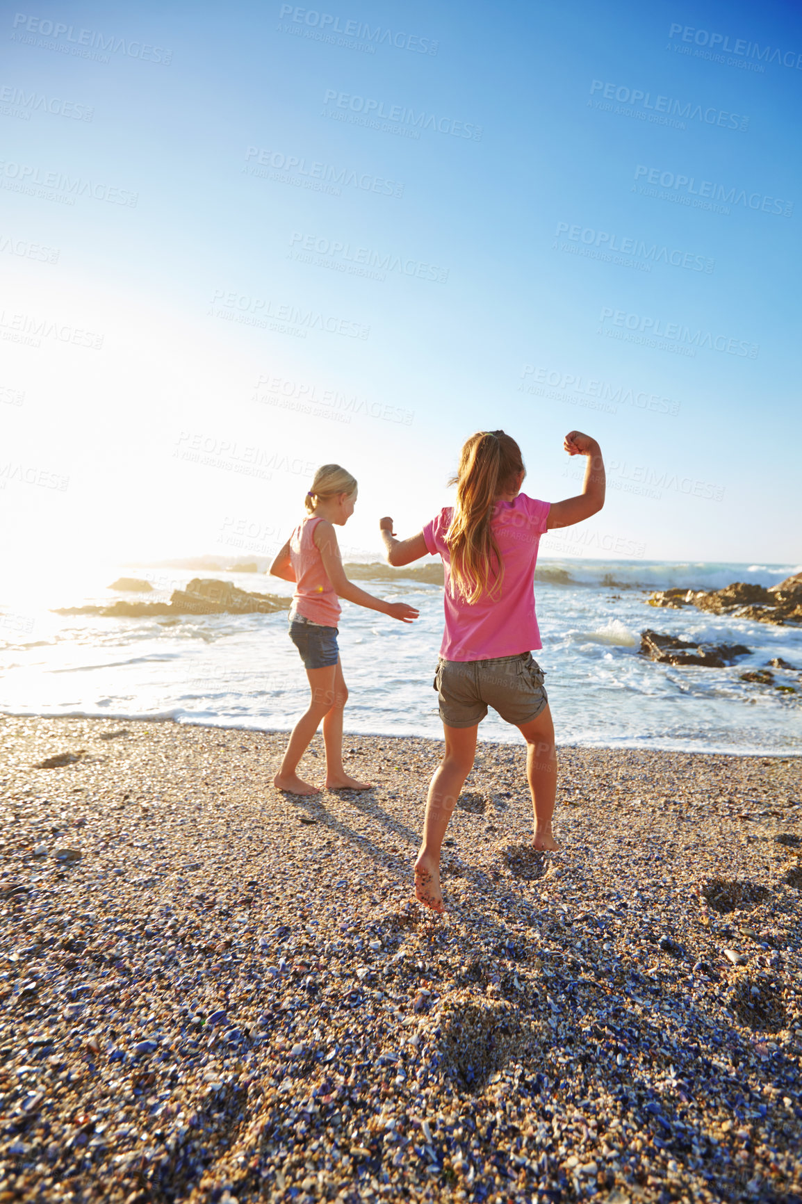 Buy stock photo Shot of two little girls having fun on the beach