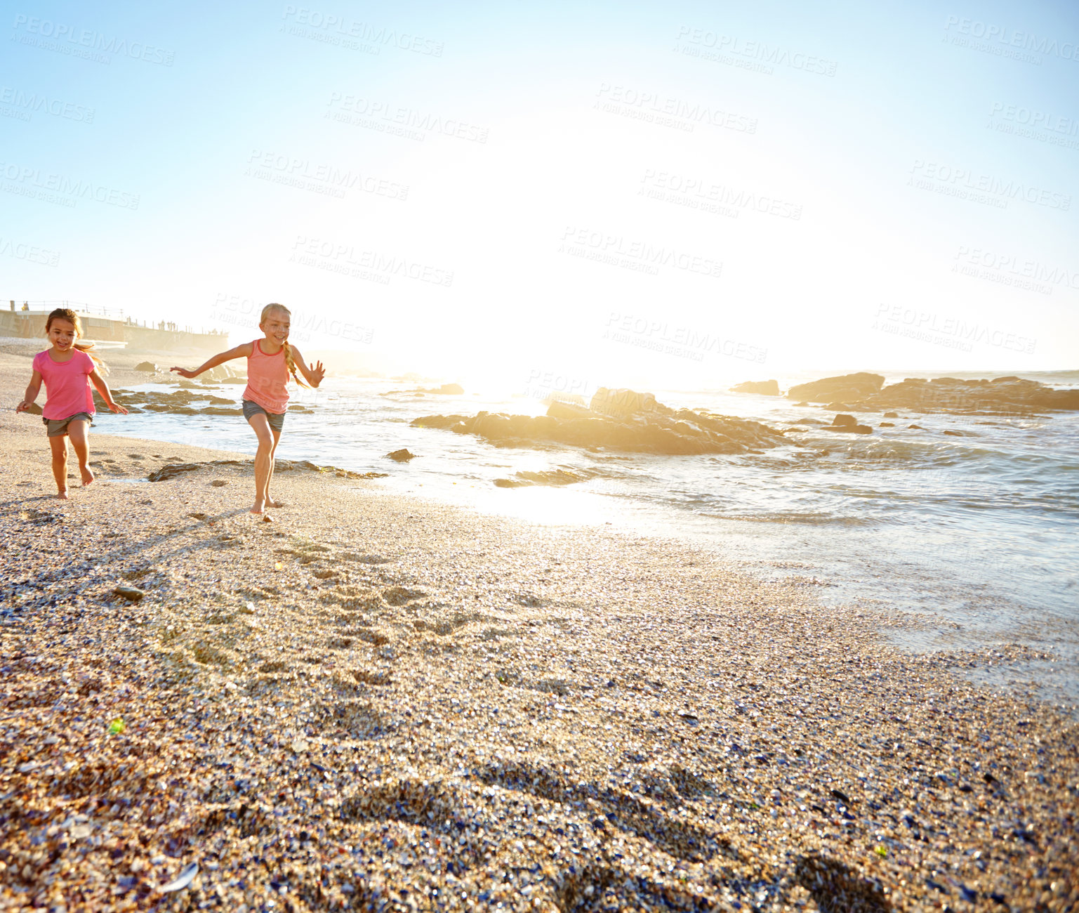 Buy stock photo Shot of two little girls having fun on the beach