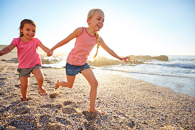 Buy stock photo Shot of two little girls having fun on the beach