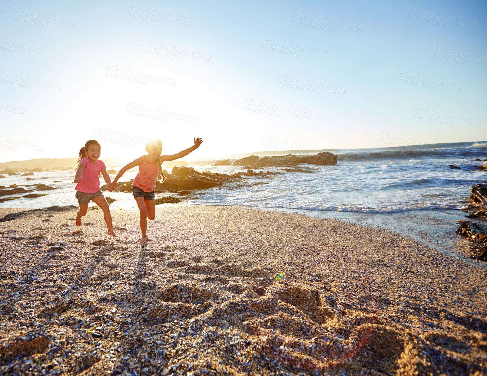 Buy stock photo Shot of two little girls having fun on the beach