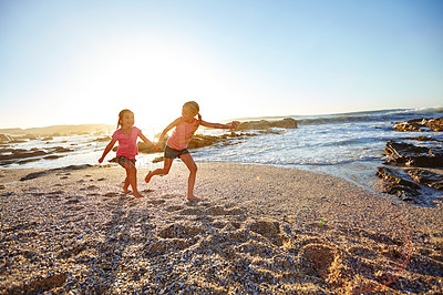 Buy stock photo Shot of two little girls having fun on the beach