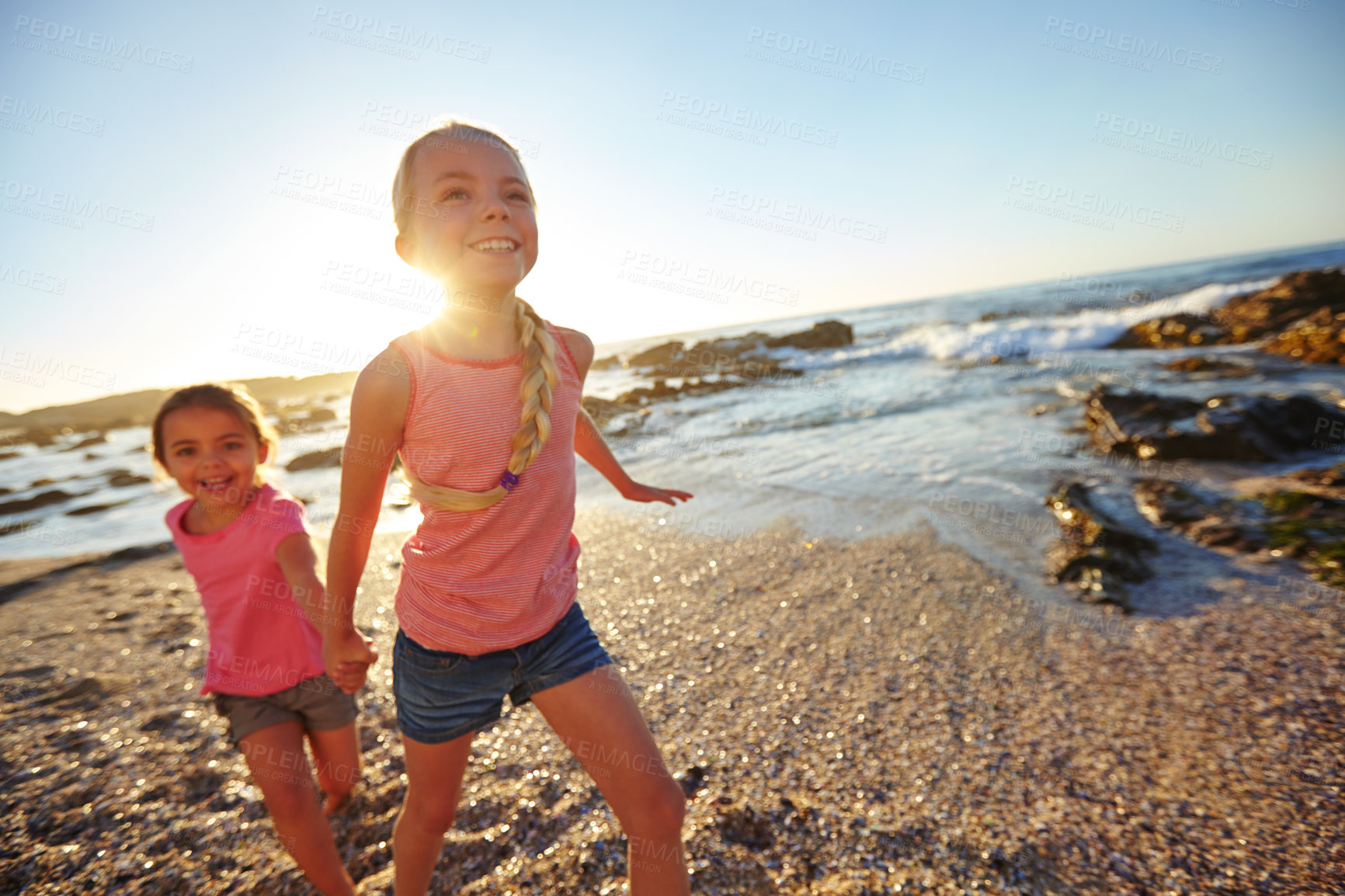 Buy stock photo Shot of two little girls having fun on the beach