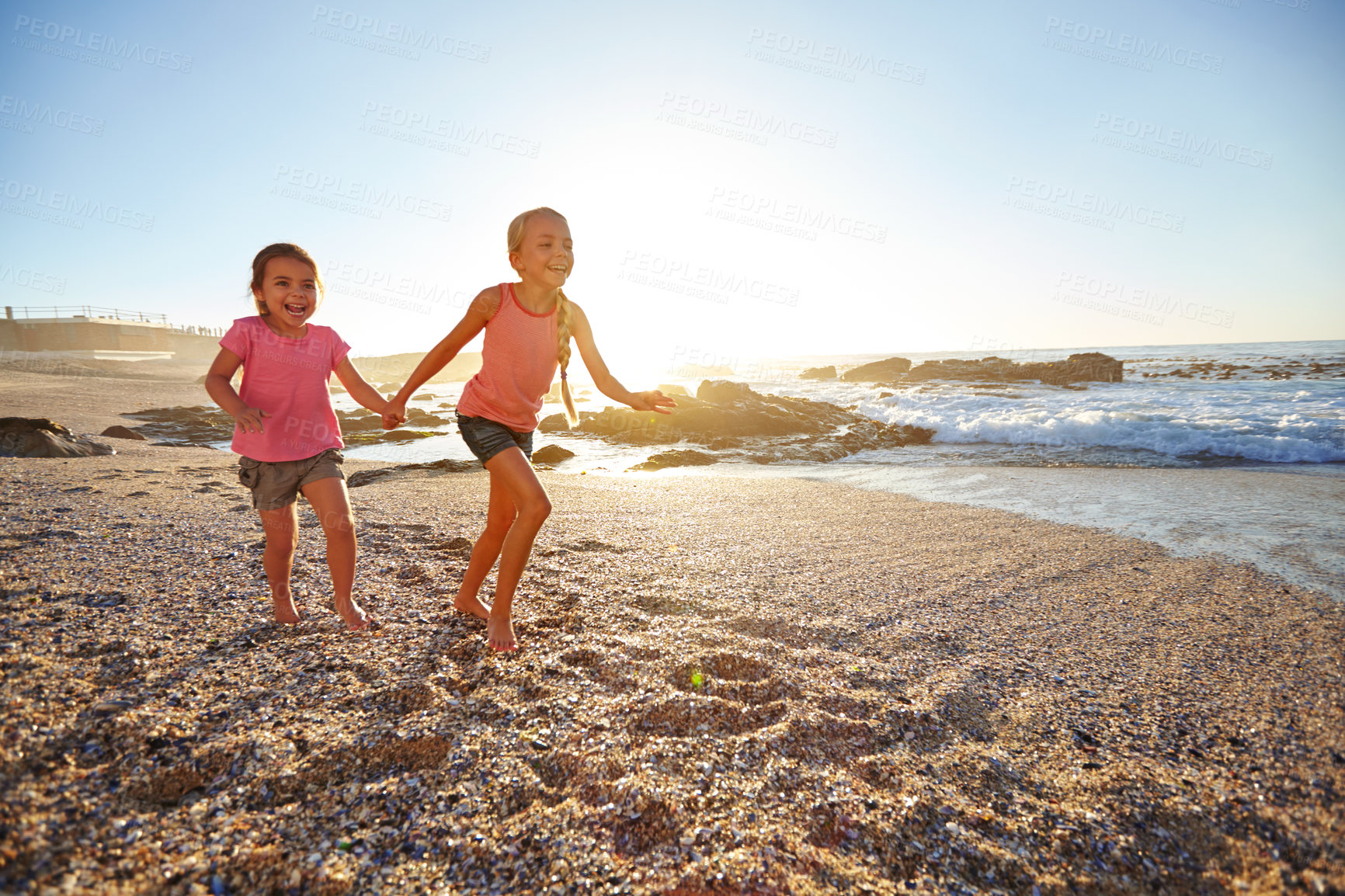 Buy stock photo Shot of two little girls having fun on the beach