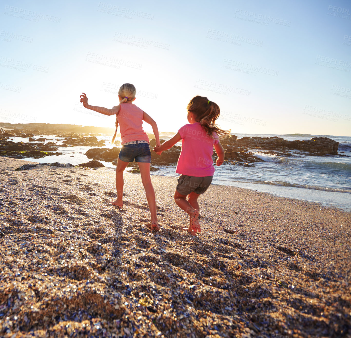 Buy stock photo Shot of two little girls having fun on the beach