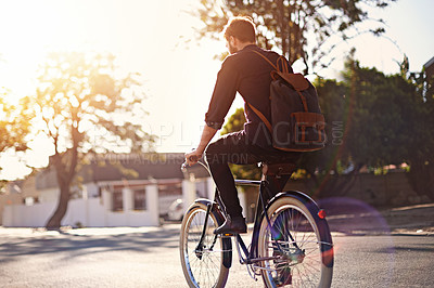 Buy stock photo Travel, bicycle and back of man in road with lens flare for exercise, commute and cycling in morning. Transport, city and male cyclist on bike for eco friendly traveling, carbon footprint and journey