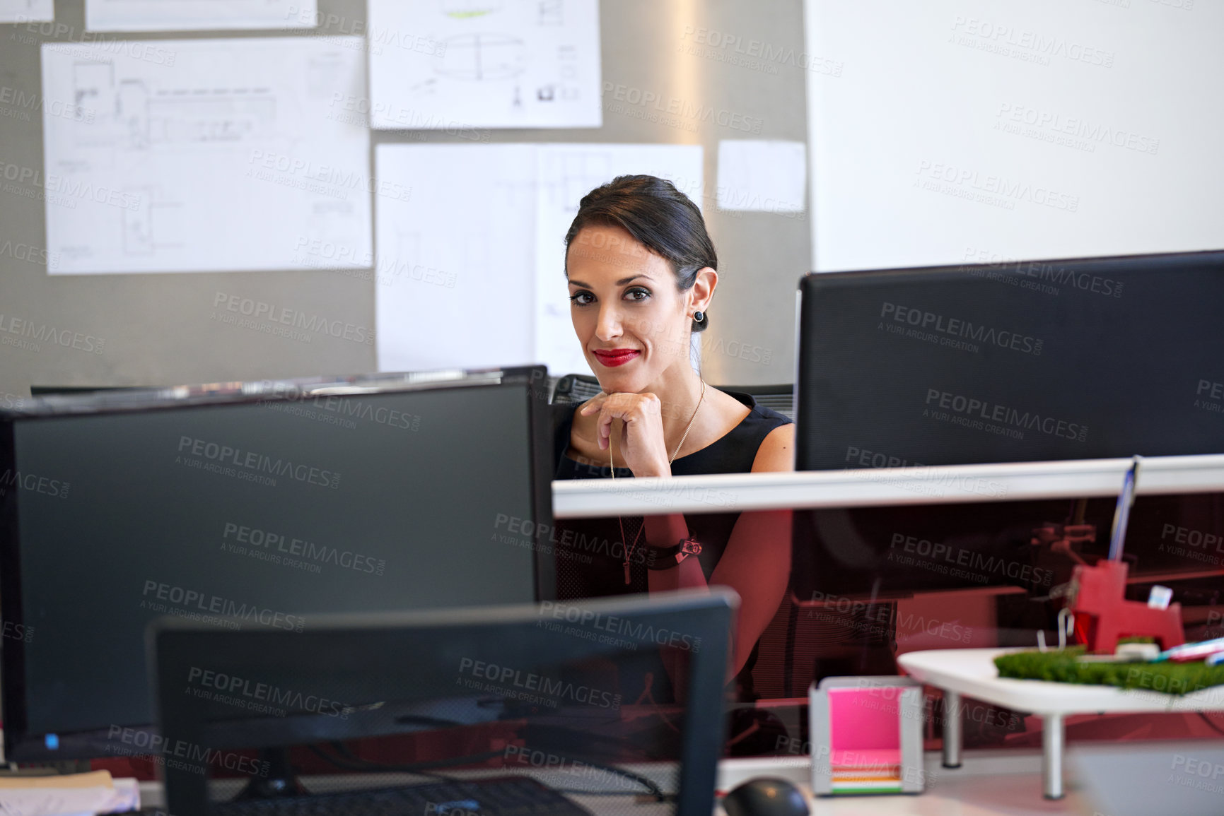 Buy stock photo Shot of a woman sitting at her workstation in an office