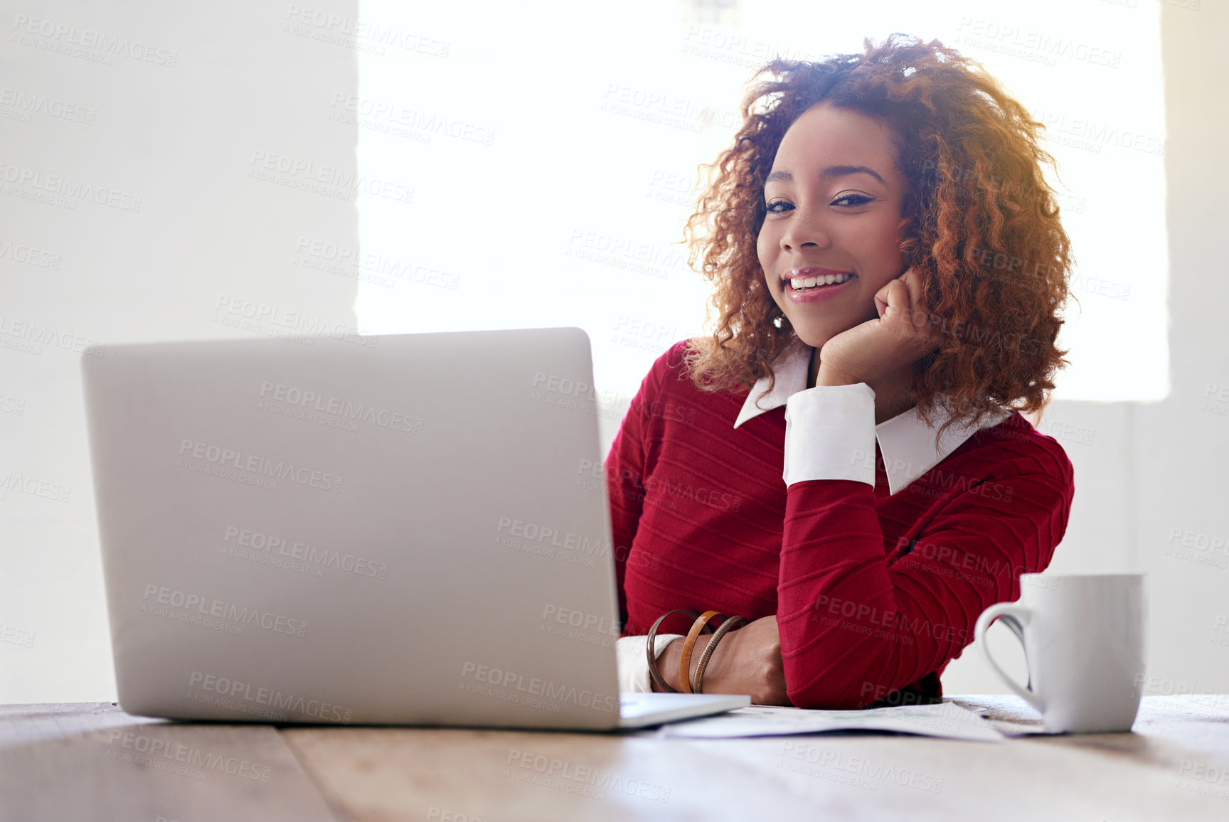 Buy stock photo Shot of a young woman working on a laptop in an office