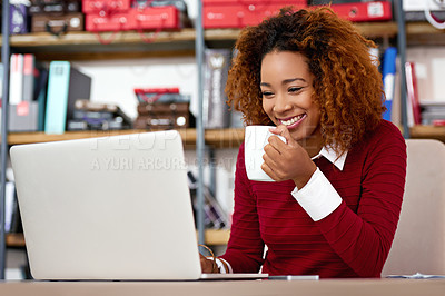 Buy stock photo Shot of a young woman working on a laptop in an office