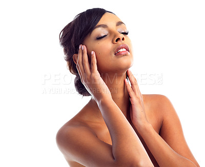 Buy stock photo Studio shot of a young woman touching her perfect skin against a white background