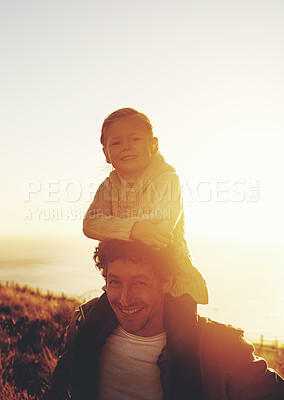 Buy stock photo Shot of a father carrying his little girl on his shoulders while walking outdoors