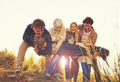 Buy stock photo Shot of a multi-generational family having fun on a hill top