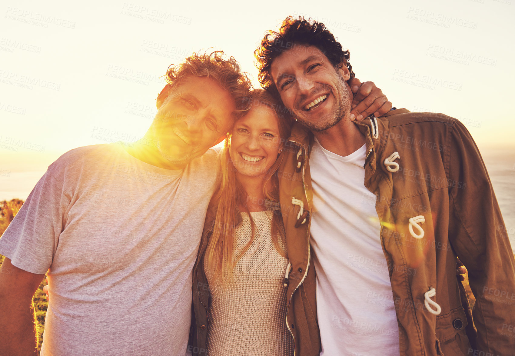 Buy stock photo Portrait of three friends standing on a hill top at sunset