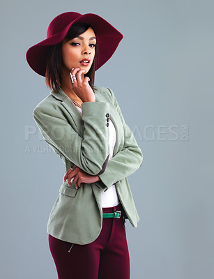 Buy stock photo Studio portrait of a stylish young woman posing against a gray background